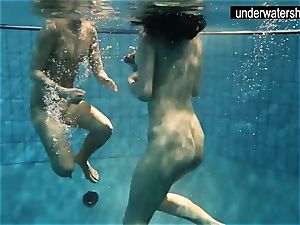 two handsome amateurs showcasing their bodies off under water